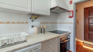 A kitchen with white cabinets, a dishwasher, a stove, and an oven. - Priolo’s Nest - Sunlit Retreat with Free Parking (Unknown)