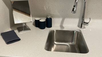 Luxury Condo, Kitchen, Partial Lake View | Iron/ironing board, free WiFi