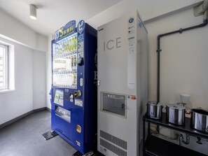 A vending machine with a variety of beverages and a large ice dispenser unit.