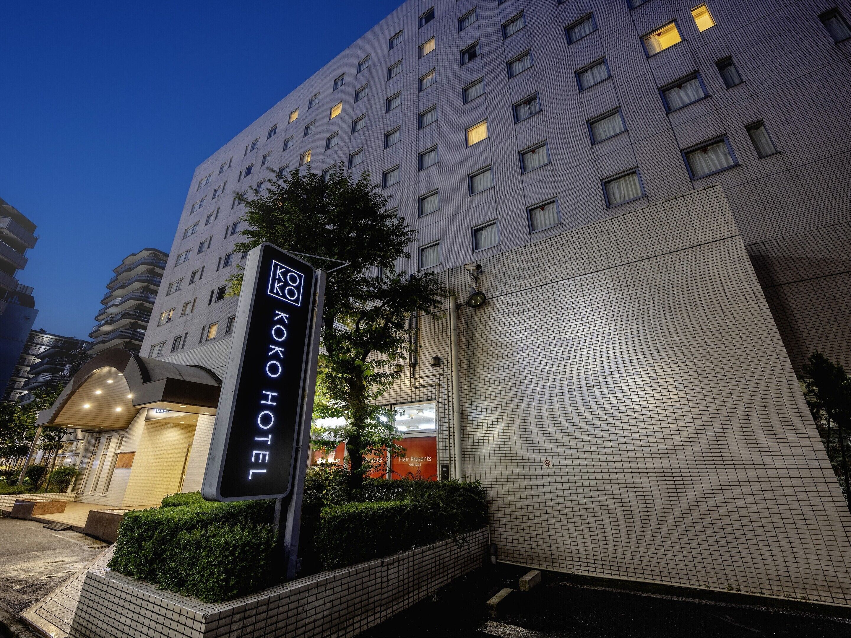 A hotel entrance with a sign reading "KOKO HOTEL".
