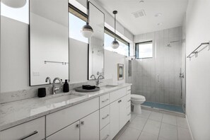 Shower, hair dryer, towels, toilet paper