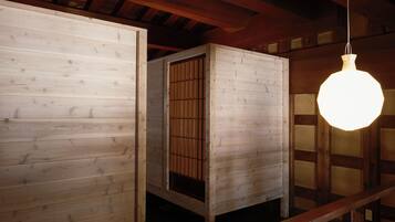 A room with wooden walls and a hanging light fixture.