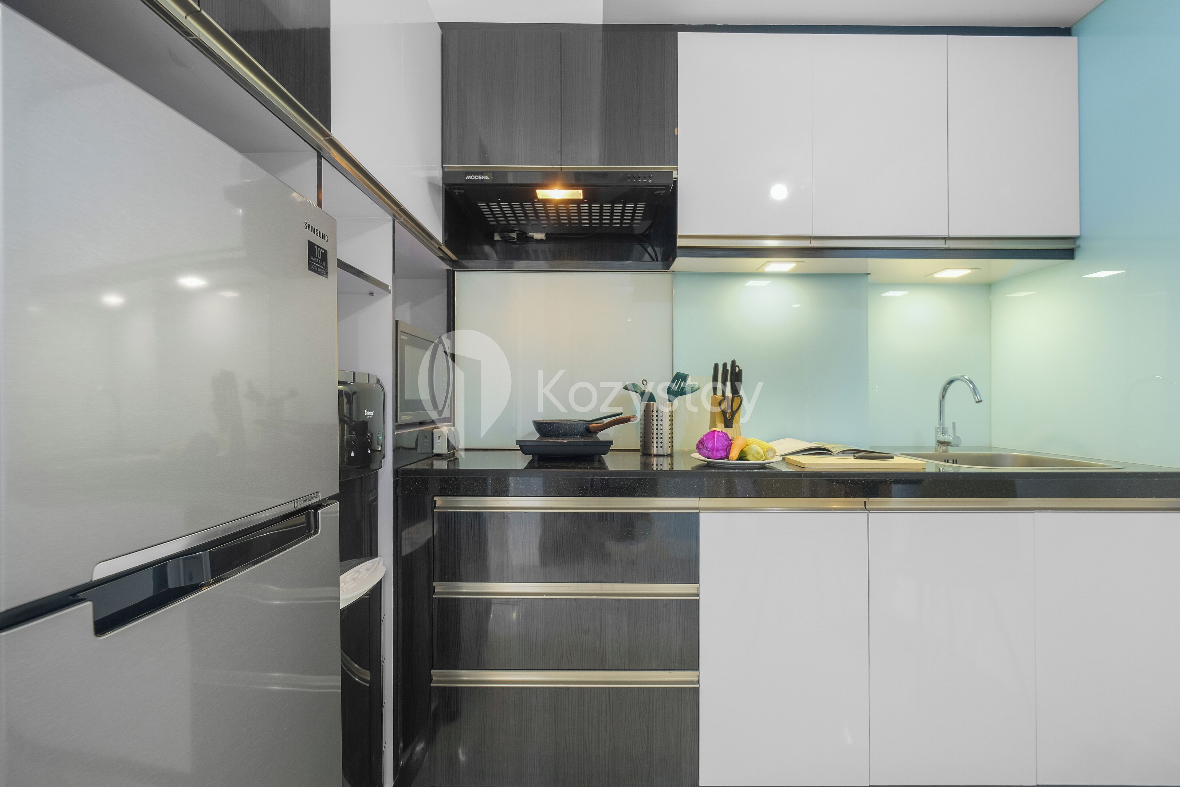 A modern kitchen with stainless steel appliances, a built-in oven, and a microwave.