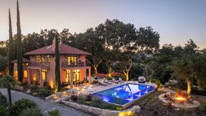 A two-story house with a swimming pool, outdoor seating, and a well-maintained garden. - Paso Paradiso (Paso Robles)