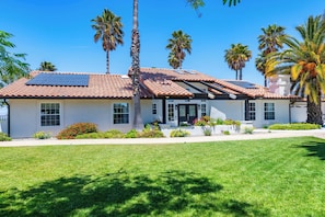 A house with a tiled roof, solar panels, and a well-maintained lawn. - Hilltop Oasis (Templeton)