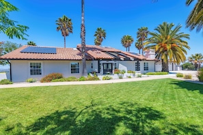 A modern house with a tiled roof, solar panels, and a well-maintained lawn. - Hilltop Oasis (Templeton)