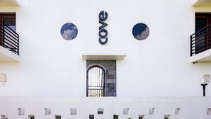 A building facade with the word "cove" prominently displayed in the center. - Cove Kisah Residence (Munggu)
