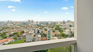 A cityscape viewed from a high vantage point, featuring a mix of residential and commercial buildings, with a clear sky and no visible weather conditions. - Brenna by Kozystay - Menteng (Jakarta)