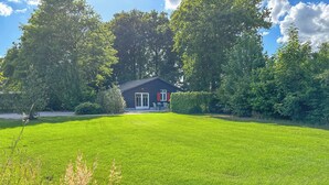A house with a well-maintained lawn and a patio area.
