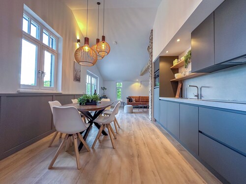 Green-surrounded luxury home with a hot tub