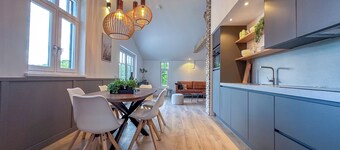 Green-surrounded luxury home with a hot tub