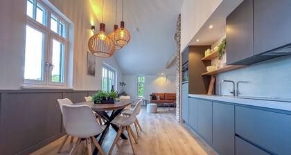 Green-surrounded luxury home with a hot tub