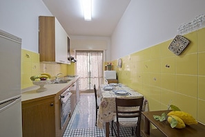 Stovetop, coffee/tea maker, cookware/dishes/utensils, dining tables