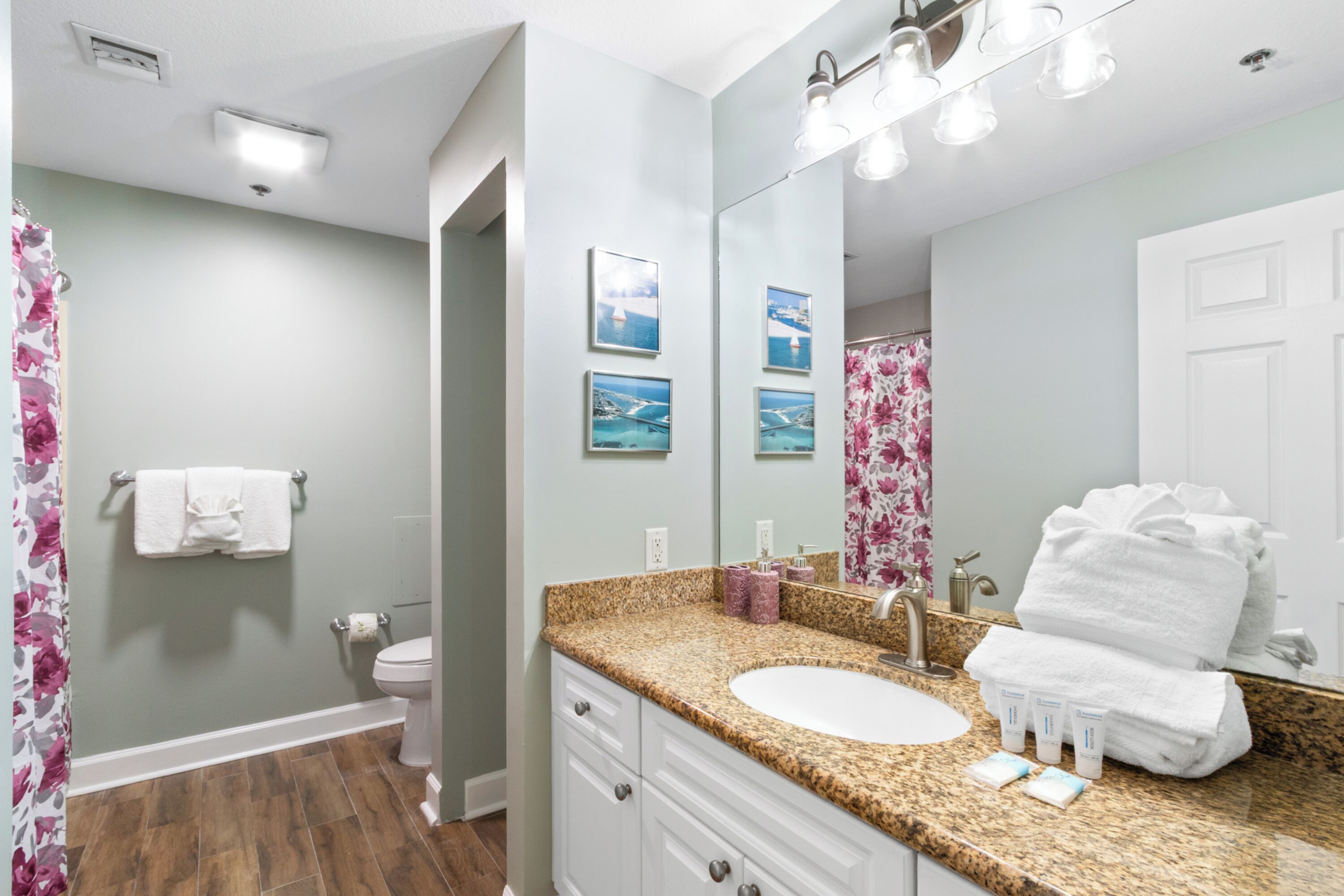 A bathroom with a sink, mirror, and towel rack.