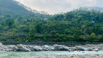 A river with rocky banks and a mountainous backdrop.