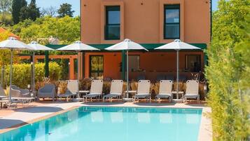 Seasonal outdoor pool, open 9:00 AM to 7:00 PM, pool umbrellas