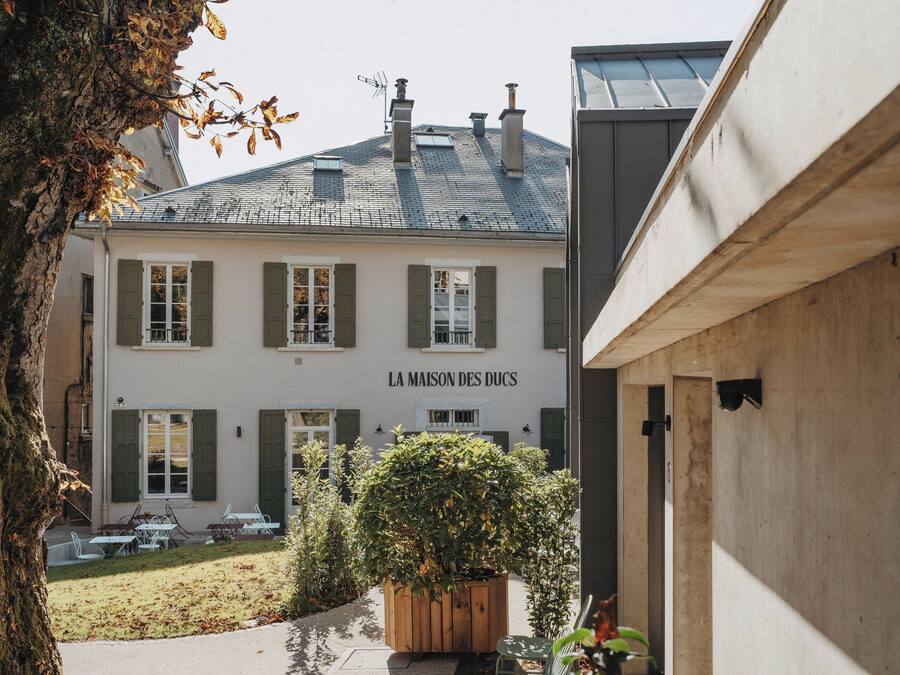 A building with a sign reading "LA MAISON DES DUCS".