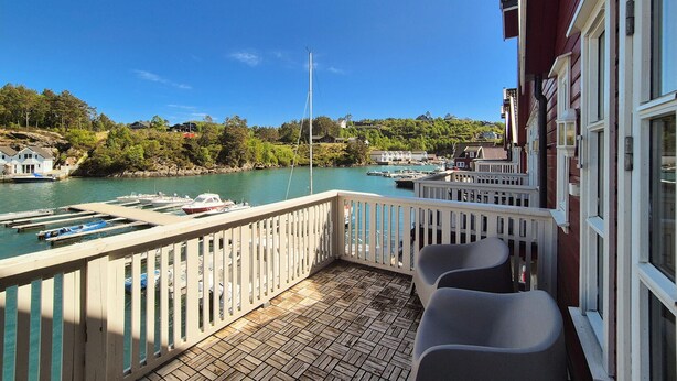 A balcony with a view of a marina and houses.