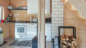 Una cocina moderna con armarios blancos, horno integrado y salpicadero de azulejos.