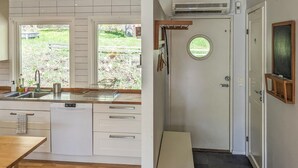 A compact kitchen with a sink, dishwasher, and a window overlooking a garden. - Gorgeous home in Hovås with WiFi (Hovås)