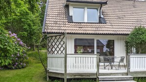 A house with a covered porch, a window, and a door. - Gorgeous home in Hovås with WiFi (Hovås)