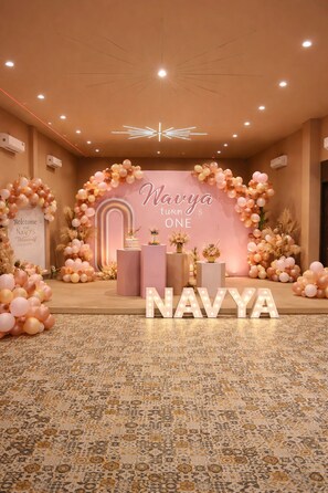 A decorated event space with a central stage, balloons, and illuminated letters spelling 'NAVYYA'. - Pallacia A Luxury Hotel (Beawar)