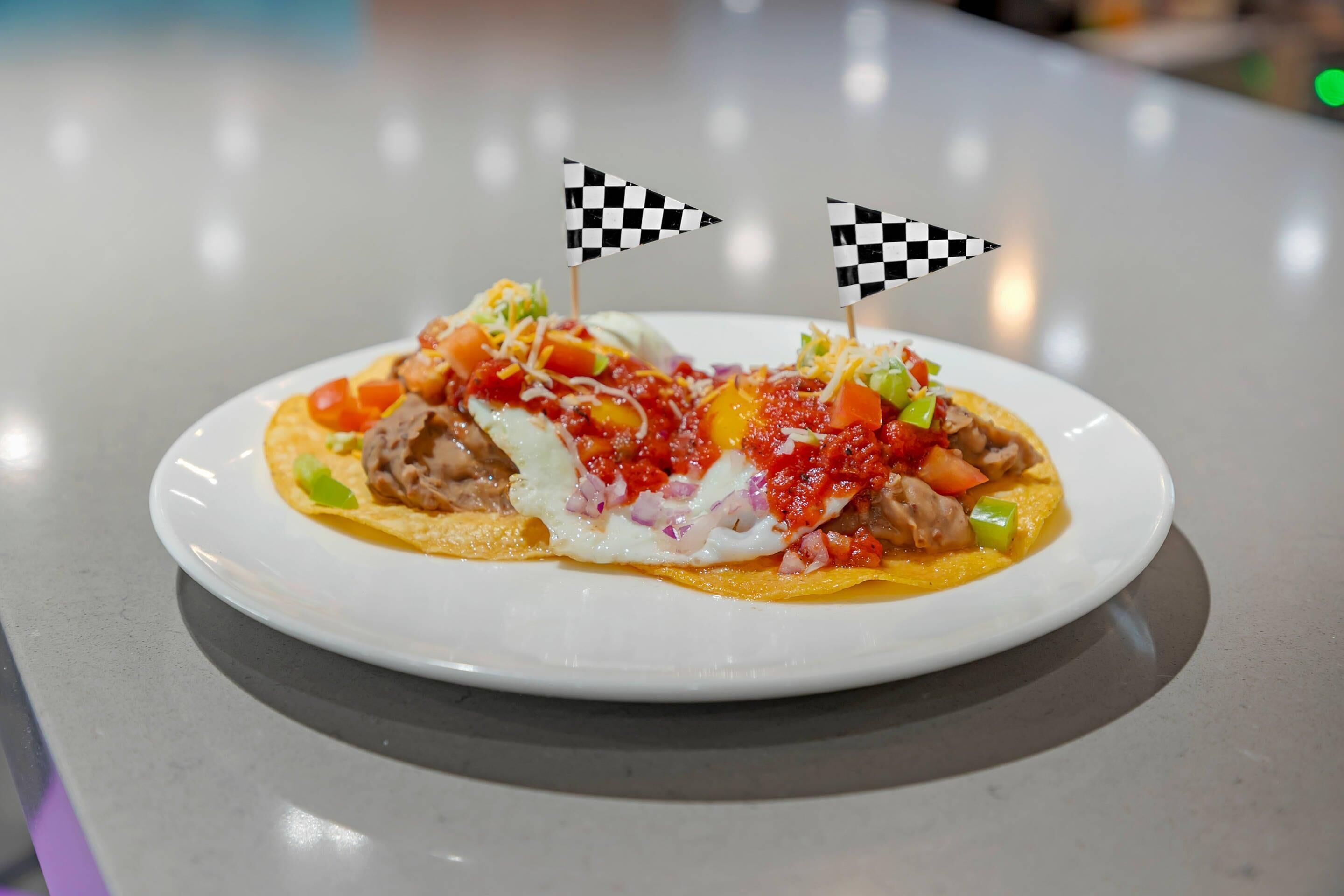 A plate of food with two checkered flags on top.