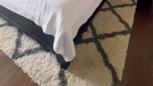 A bedroom with a bed, nightstands, a wall clock, and a rug. - Charming 2-bedroom farmhouse in delightful Auburn with AC, WiFi (Auburn)