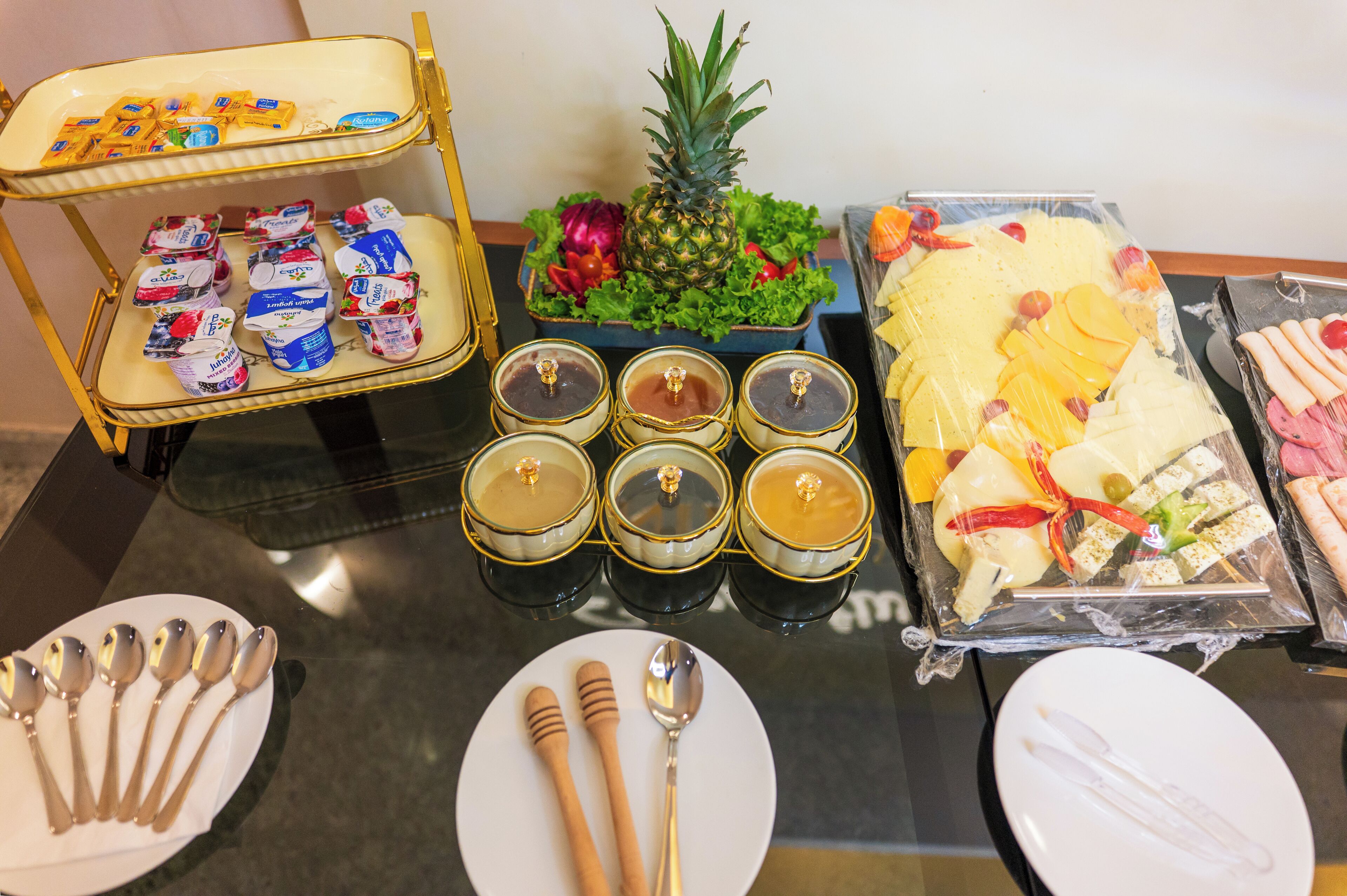 A table with food items, condiments, and utensils.