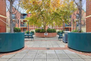 A courtyard with brick buildings, a reception sign, and outdoor seating.