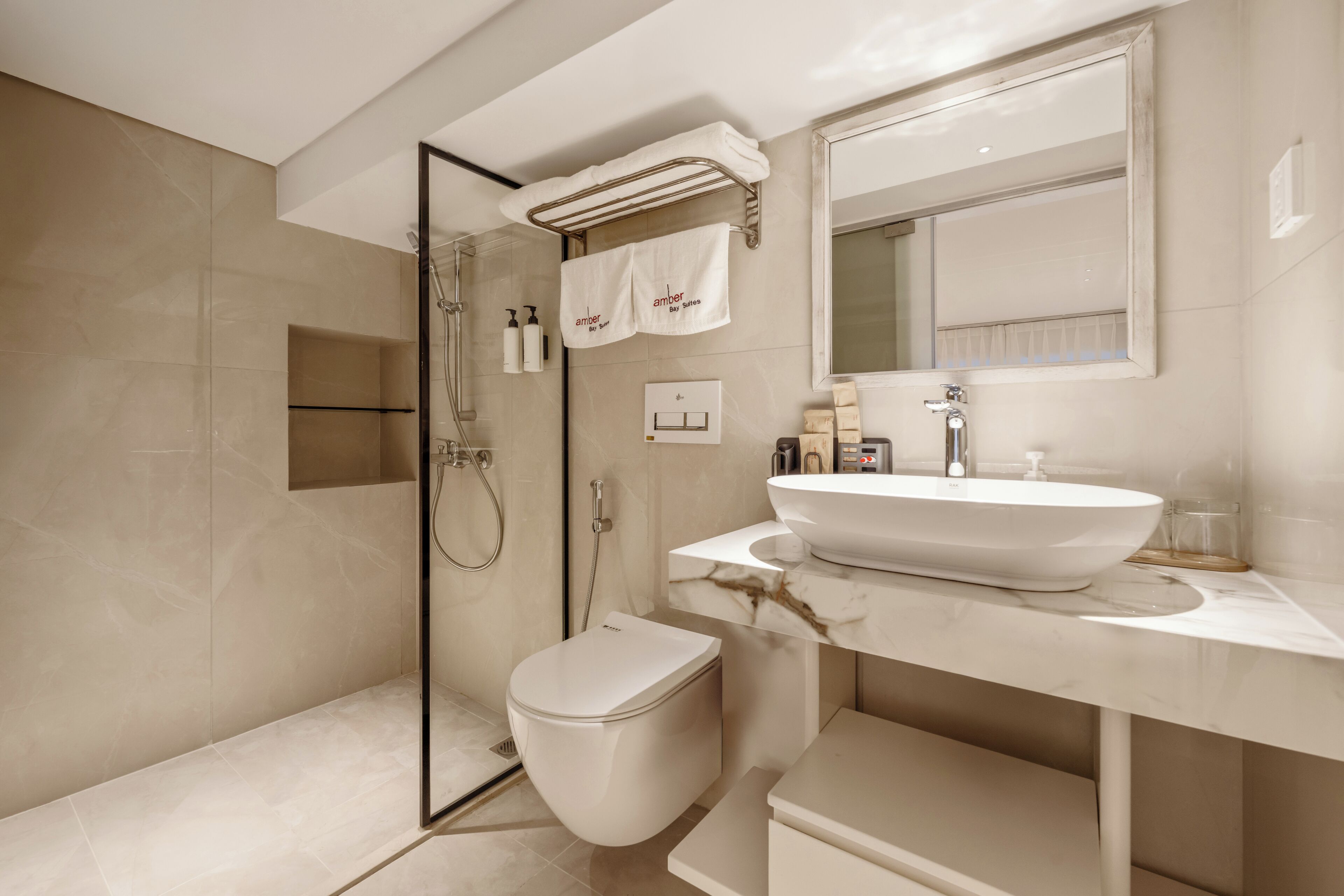A modern bathroom with a glass-enclosed shower, a white toilet, and a vanity with a large sink.