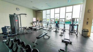 A gym with various exercise equipment, including treadmills, weight machines, and dumbbells. - Minoa by Kozystay - Thamrin (Jakarta)
