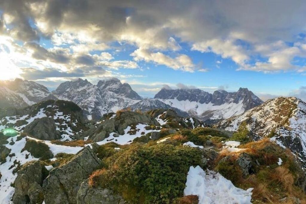 Eine Berglandschaft mit schneebedeckten Gipfeln und felsigem Gelände.
