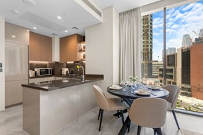 Fridge, microwave, oven, stovetop - Lavish 1-Bedroom w/ Burj Khalifa view in Peninsula (Business Bay)