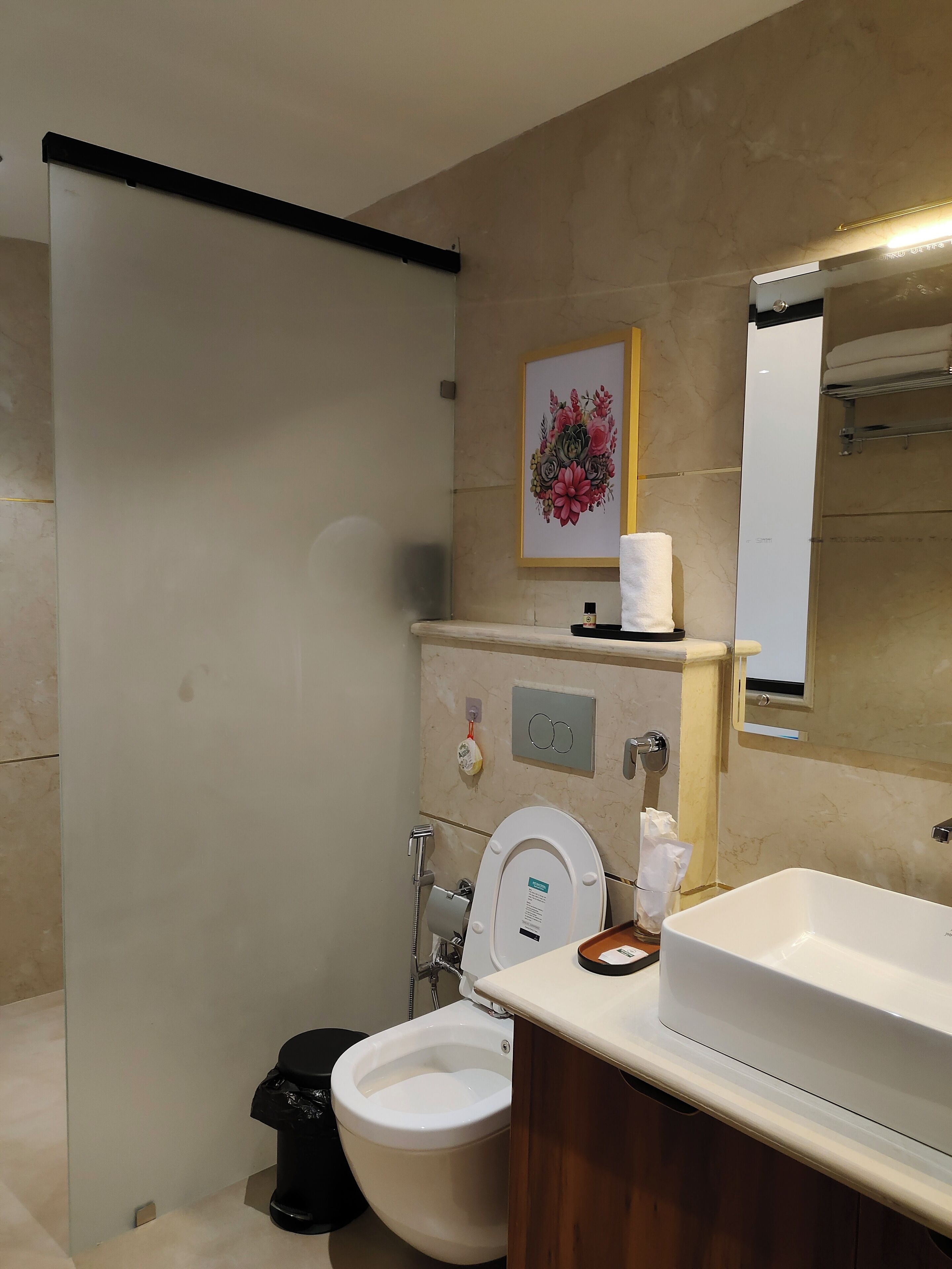 A modern bathroom with a toilet, bidet, and a large sink.