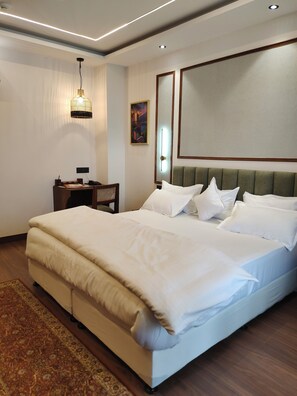 Family Room | Desk, iron/ironing board, bed sheets