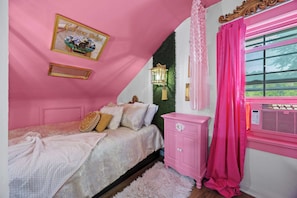 A bedroom with a pink theme, including a bed, a nightstand, and a window with curtains.