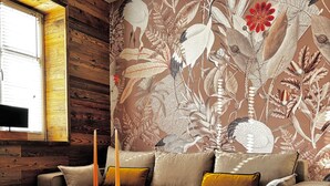 A modern living room with a sofa, a round coffee table, and a patterned rug. - Zinna Monastery Post Office (Jüterbog)