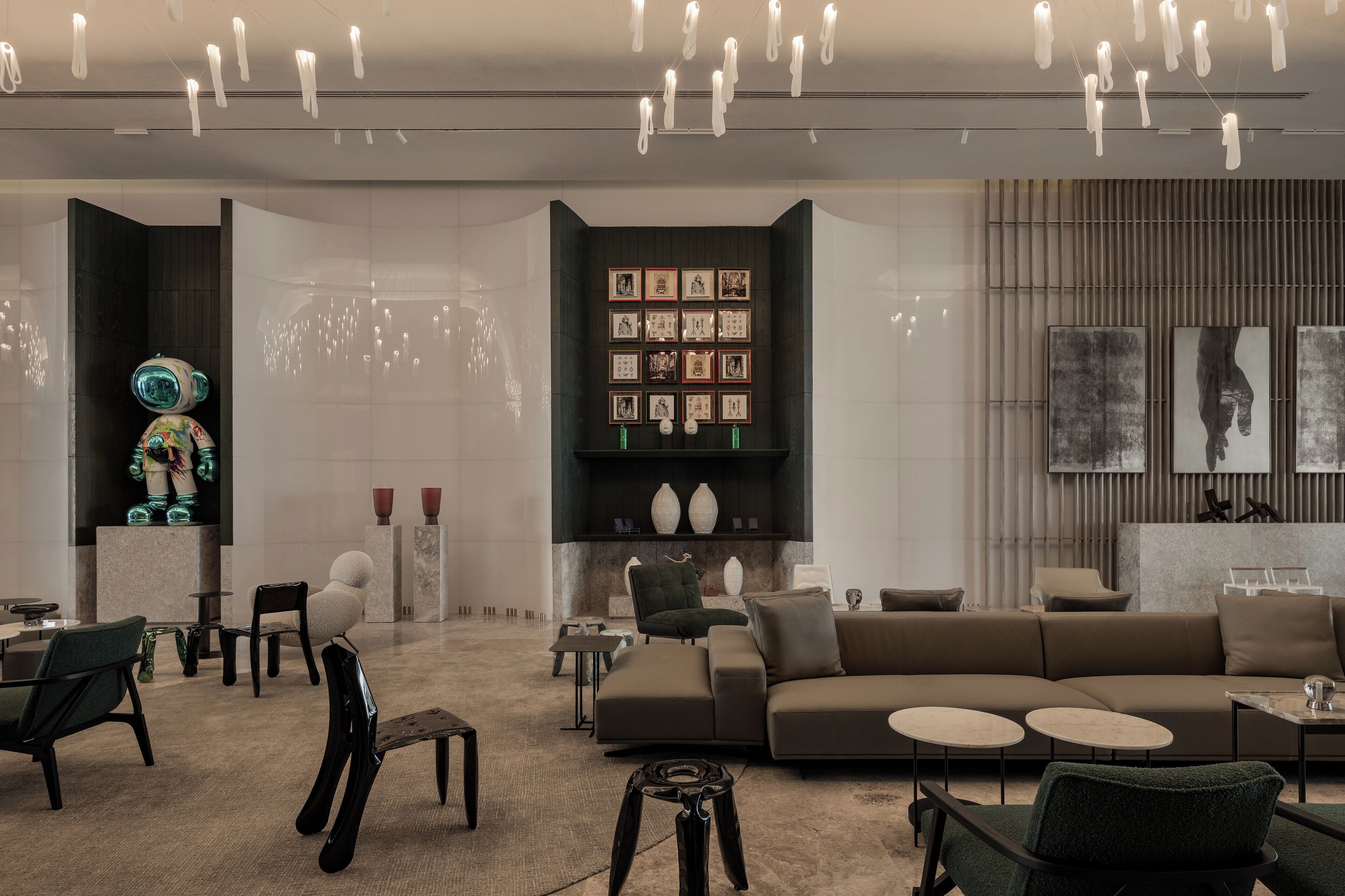 A modern interior with a sectional sofa, round coffee tables, and a decorative robot figure.
