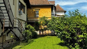 A residential building with a well-maintained lawn and a staircase leading to the entrance. - Kesletz House (Sibiu)