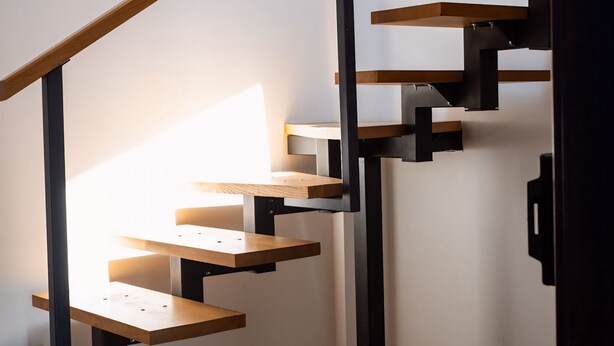 A staircase with wooden steps and black metal railings. - Kesletz House (Sibiu)