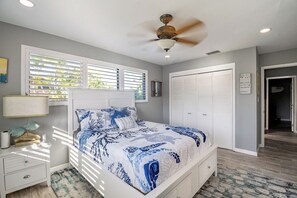 A bedroom with a bed, a nightstand, a lamp, a ceiling fan, a window with blinds, a closet, and a door leading to another room. - ‼️Punta Gorda Paradise‼️| 3BR w/ Water Views, Pool (Punta Gorda)