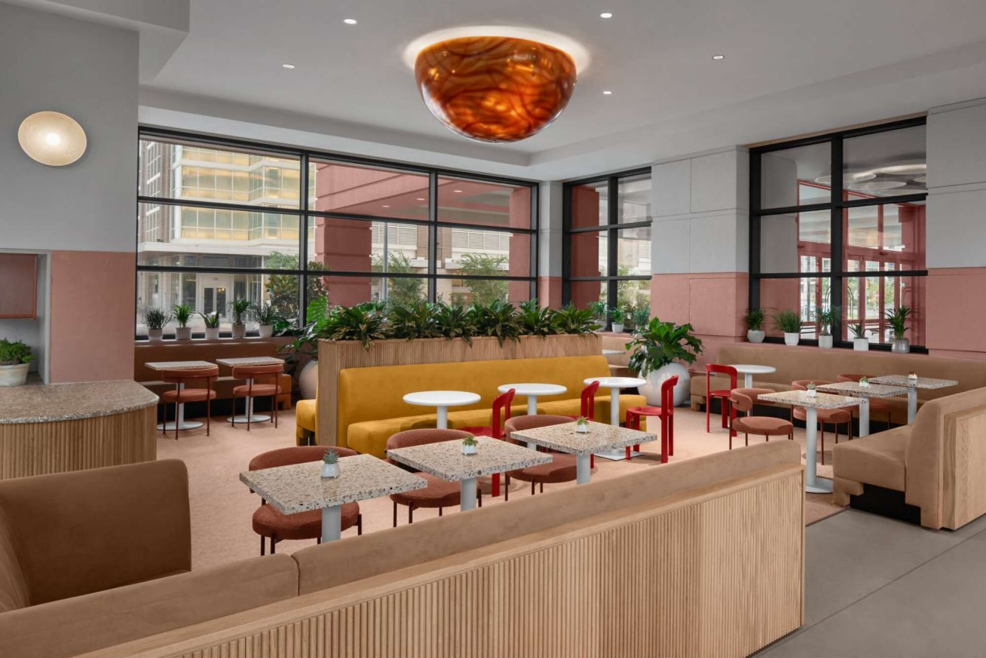 A modern interior with seating areas, tables, and large windows.