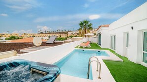 A rooftop pool area with a hot tub, lounge chairs, and a view of the surrounding neighborhood. - Villa Carlota (Costa Adeje) (Costa Adeje)