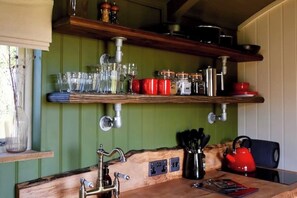 Fridge, coffee/tea maker, cookware/dishes/utensils, dining tables