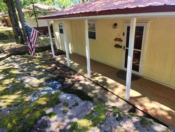 A yellow house with a red roof, a porch, and a flag. - Lake Views, Water Trail and Minutes to the Marina (Higden)