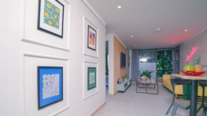 A modern living room with a sofa, coffee table, and framed artwork on the wall.