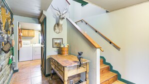 A kitchen with wooden cabinets, a sink, and a stove.