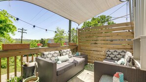 An outdoor patio with a wicker sofa, a small table, and potted plants. - 7 Mi to Dtwn: Charming Couple's Cove in Cincinnati (Cincinnati)