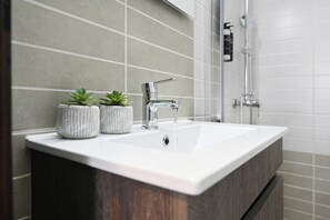 Appartement Deluxe, balcon | Salle de bain | Douche, sèche-cheveux, chaussons, serviettes fournies